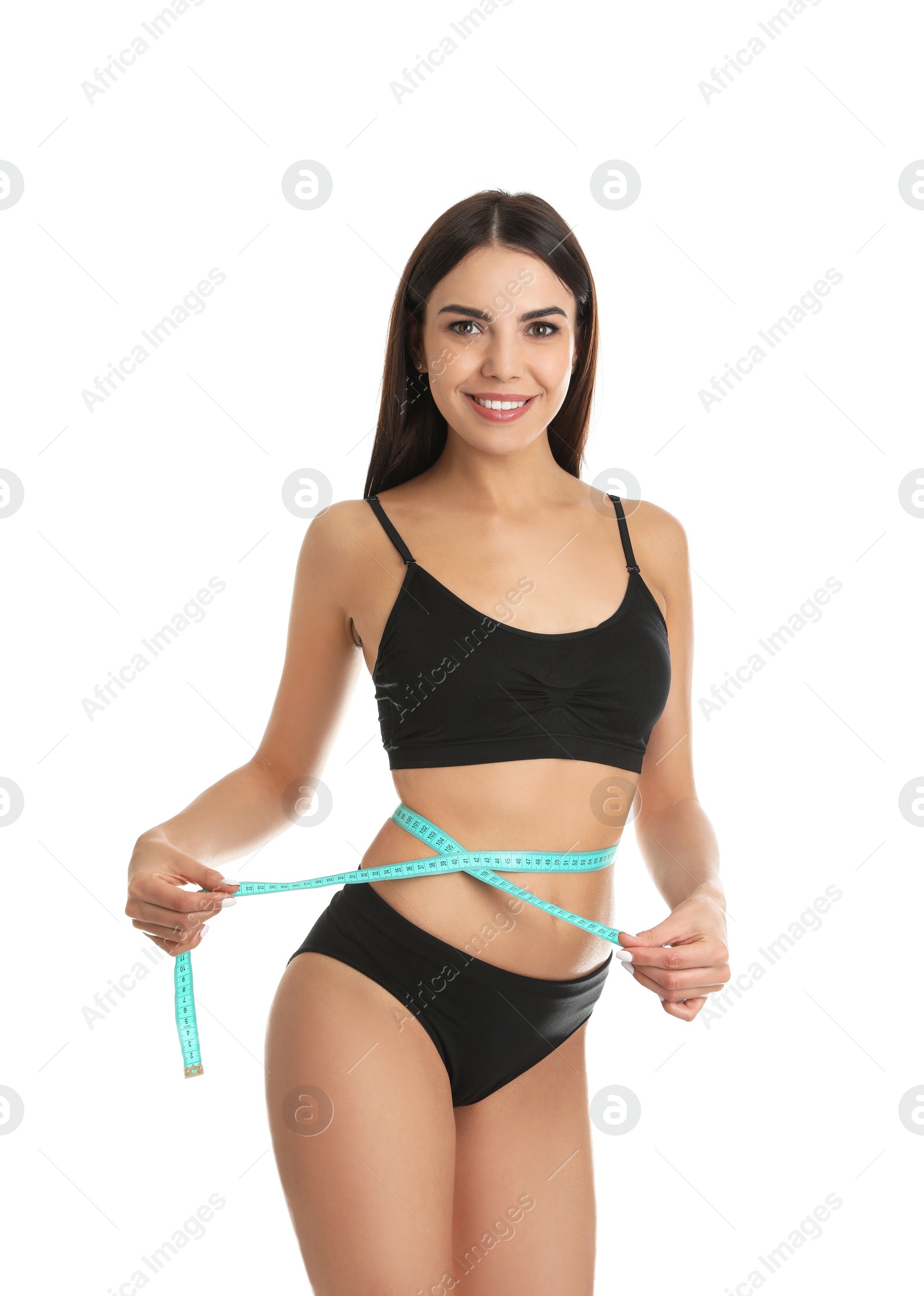 Photo of Attractive young woman with slim body measuring her waist on white background