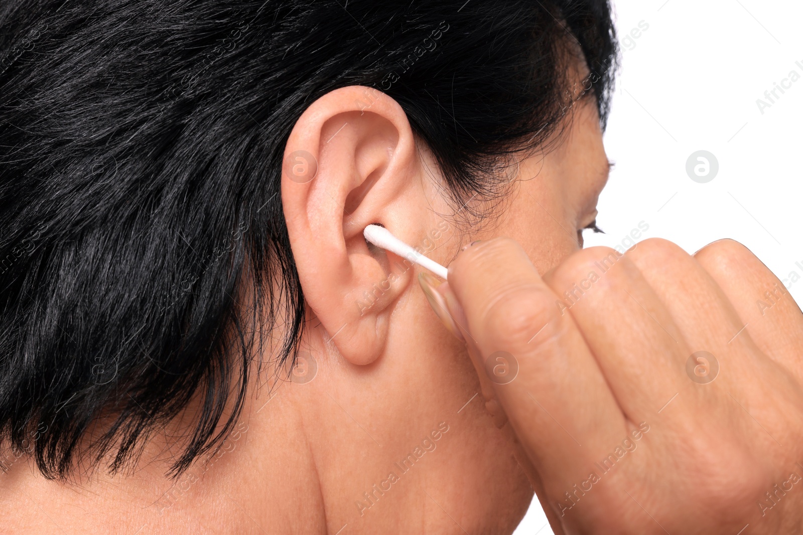 Photo of Senior woman cleaning ear with cotton swab on white background, closeup