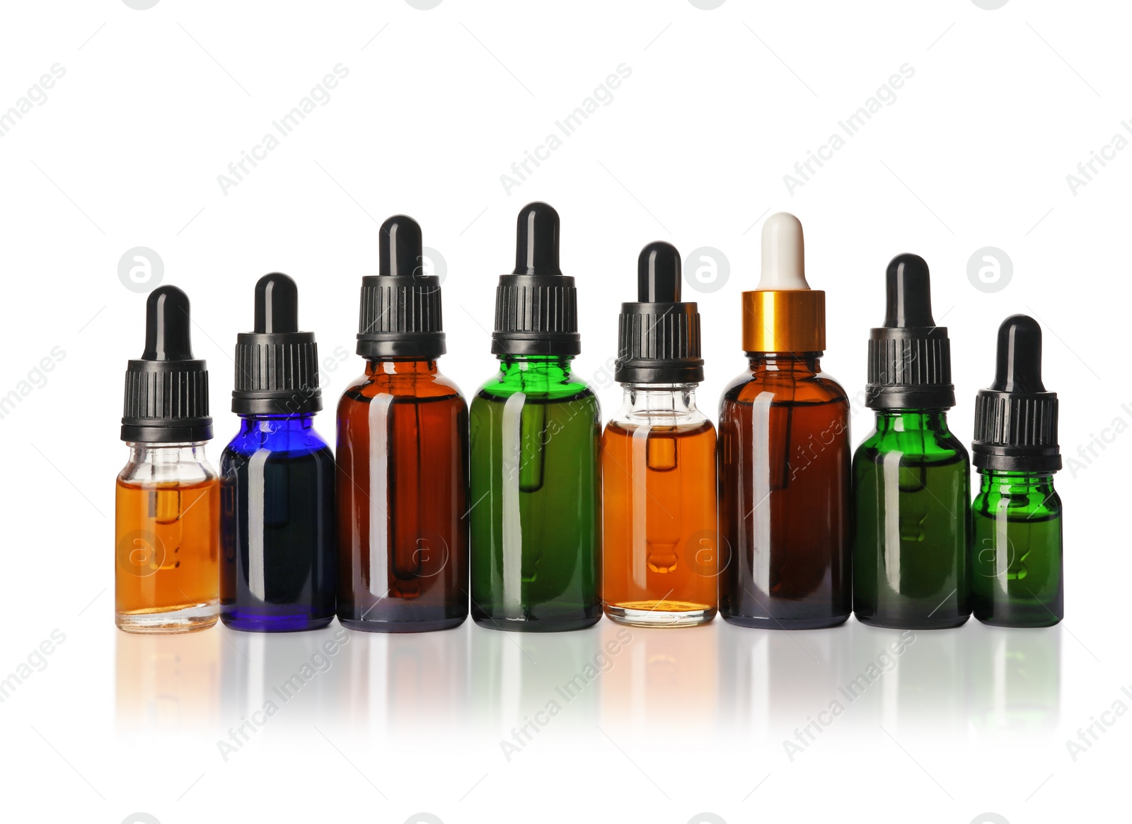 Photo of Cosmetic bottles of essential oils on white background