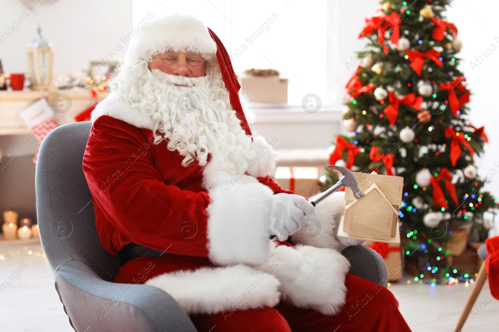 Photo of Authentic Santa Claus making toy in workshop