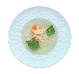 Delicious chicken bouillon with carrot and parsley in bowl on white background, top view