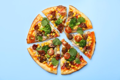 Photo of Delicious vegetarian pizza with mushrooms, vegetables and parsley on light blue background, top view