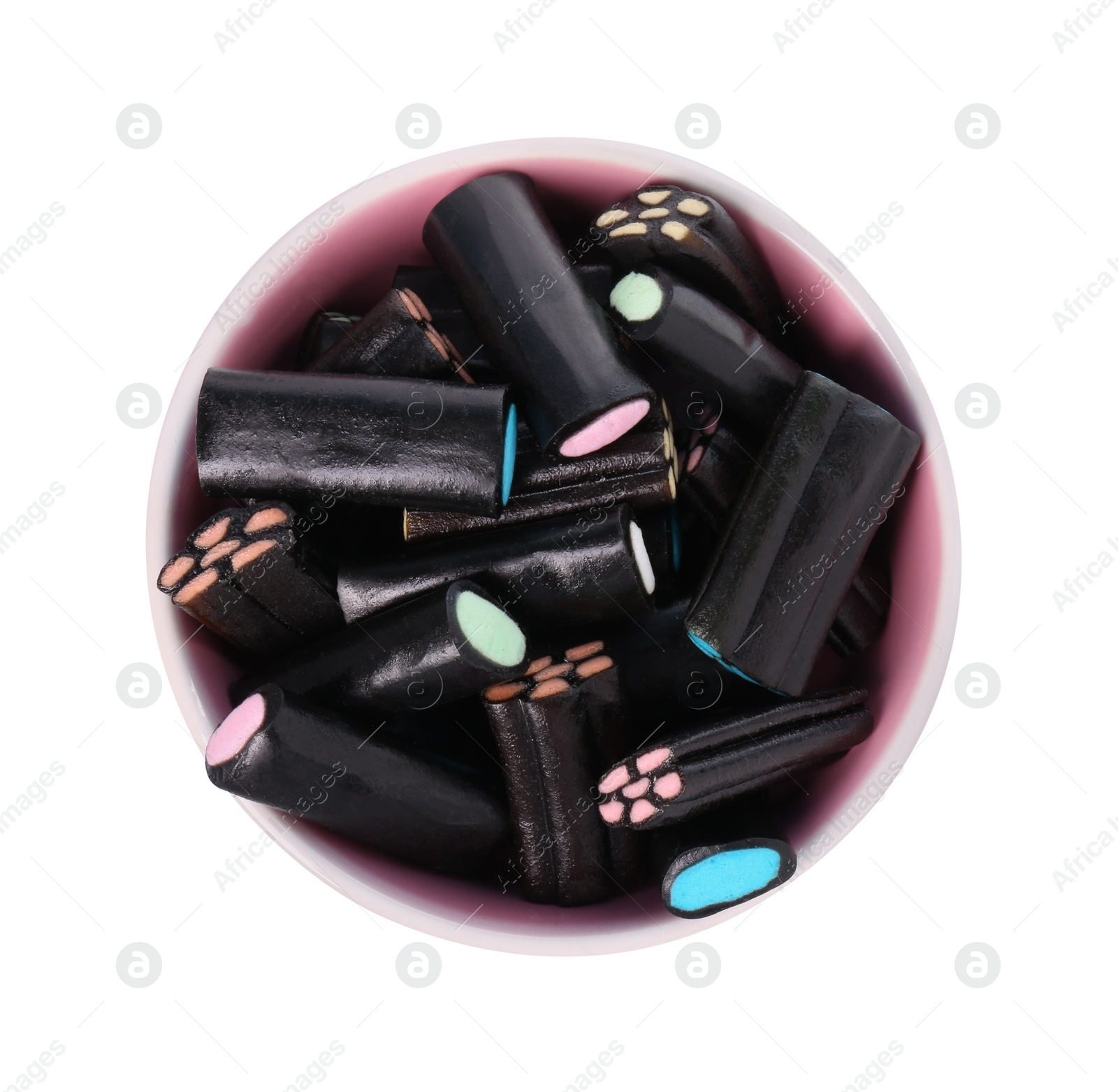 Photo of Bowl with many tasty liquorice candies isolated on white, top view