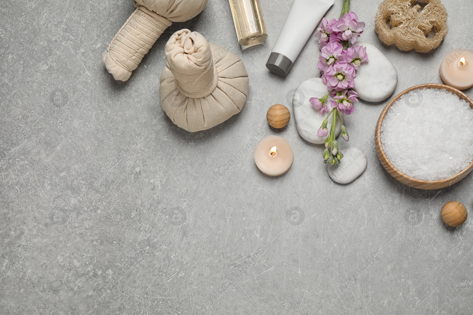 Photo of Flat lay composition with cosmetics on grey marble table, space for text. Spa treatment