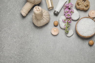 Flat lay composition with cosmetics on grey marble table, space for text. Spa treatment