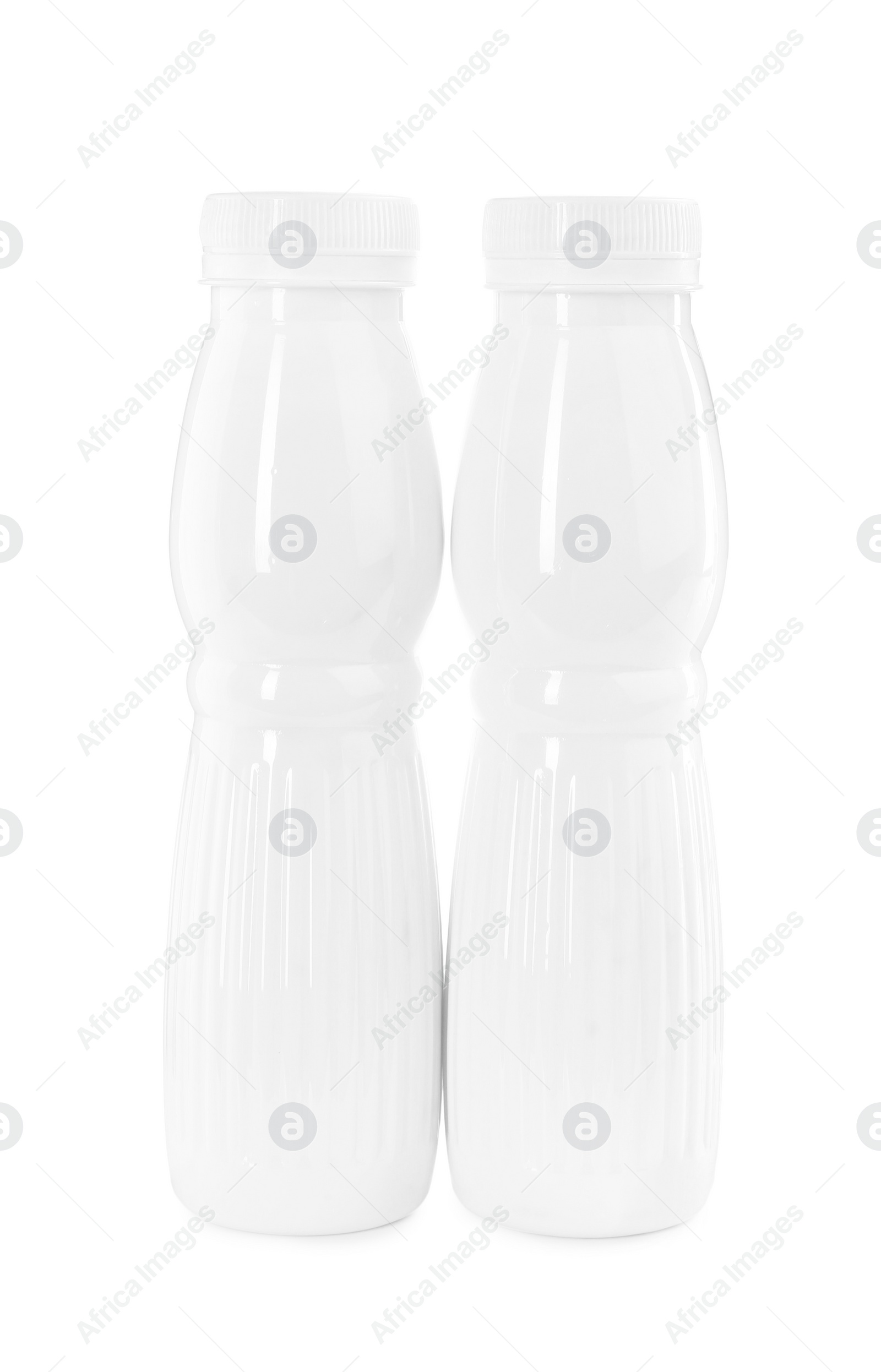 Photo of Tasty yogurt in bottles isolated on white