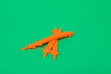 Photo of Orange silicone shoe laces on green background