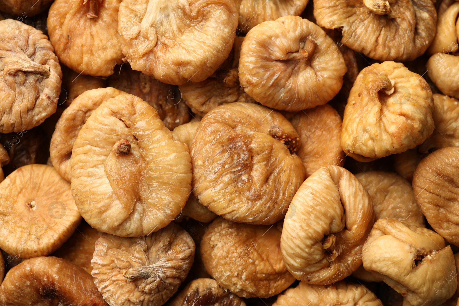 Photo of Many tasty dried figs as background, top view