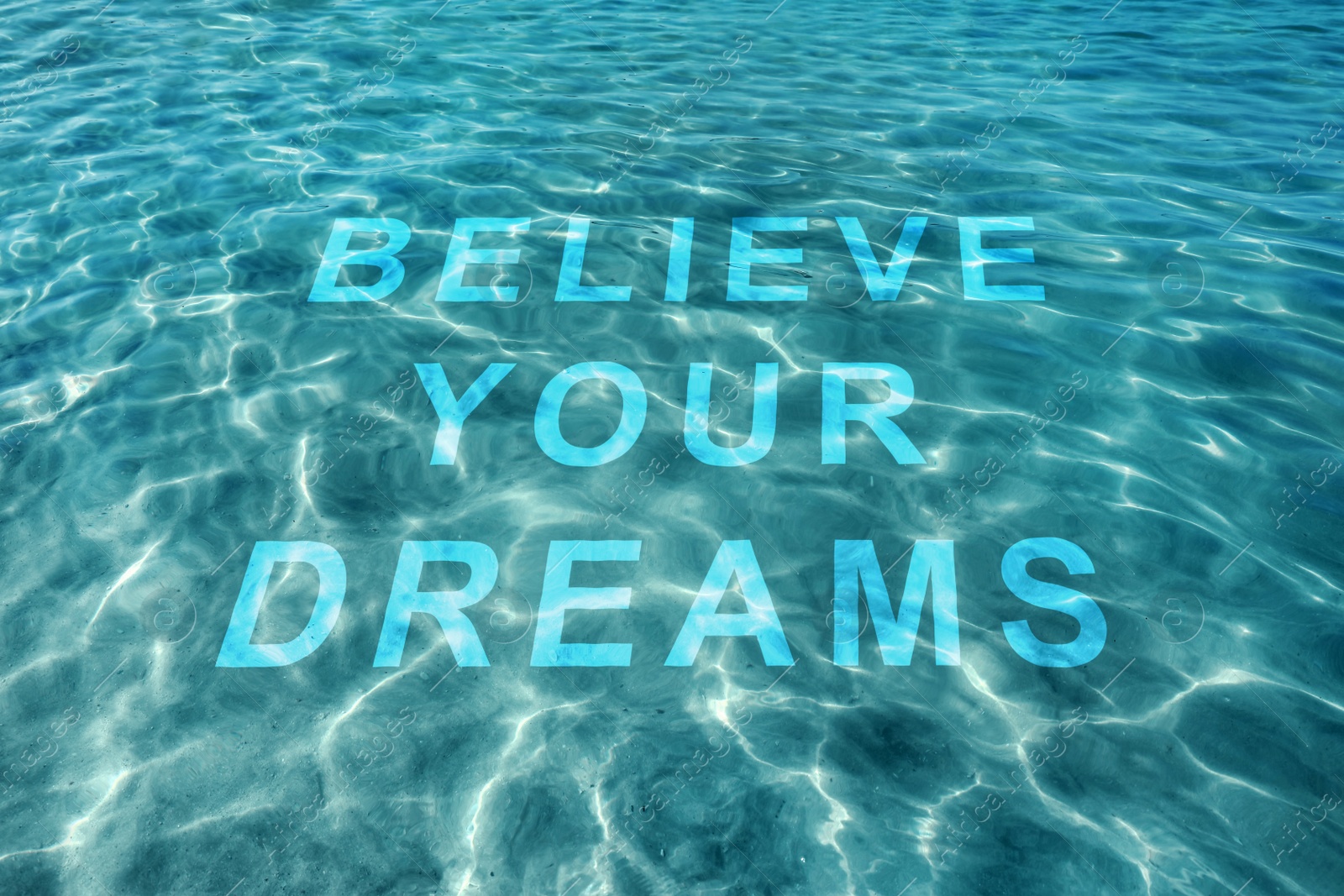 Image of Motivational quote Believe Your Dreams, view on text through ocean water