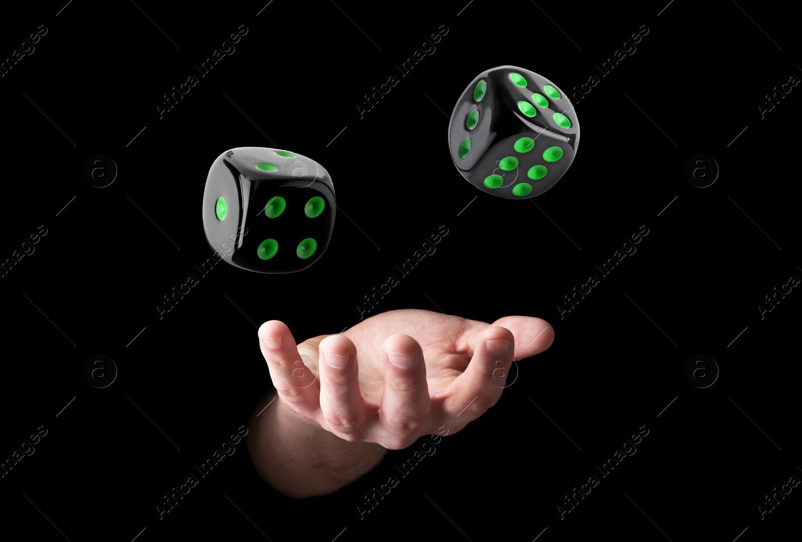 Image of Man throwing dice on black background, closeup