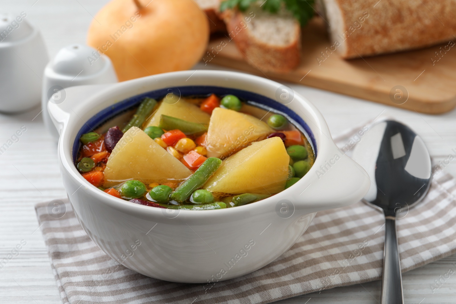 Photo of Bowl of delicious turnip soup served on white table