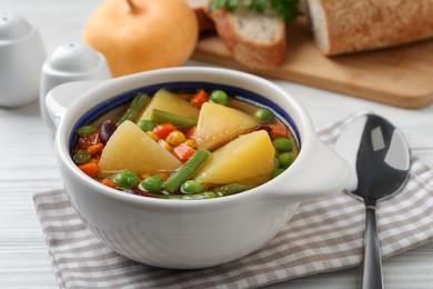 Photo of Bowl of delicious turnip soup served on white table