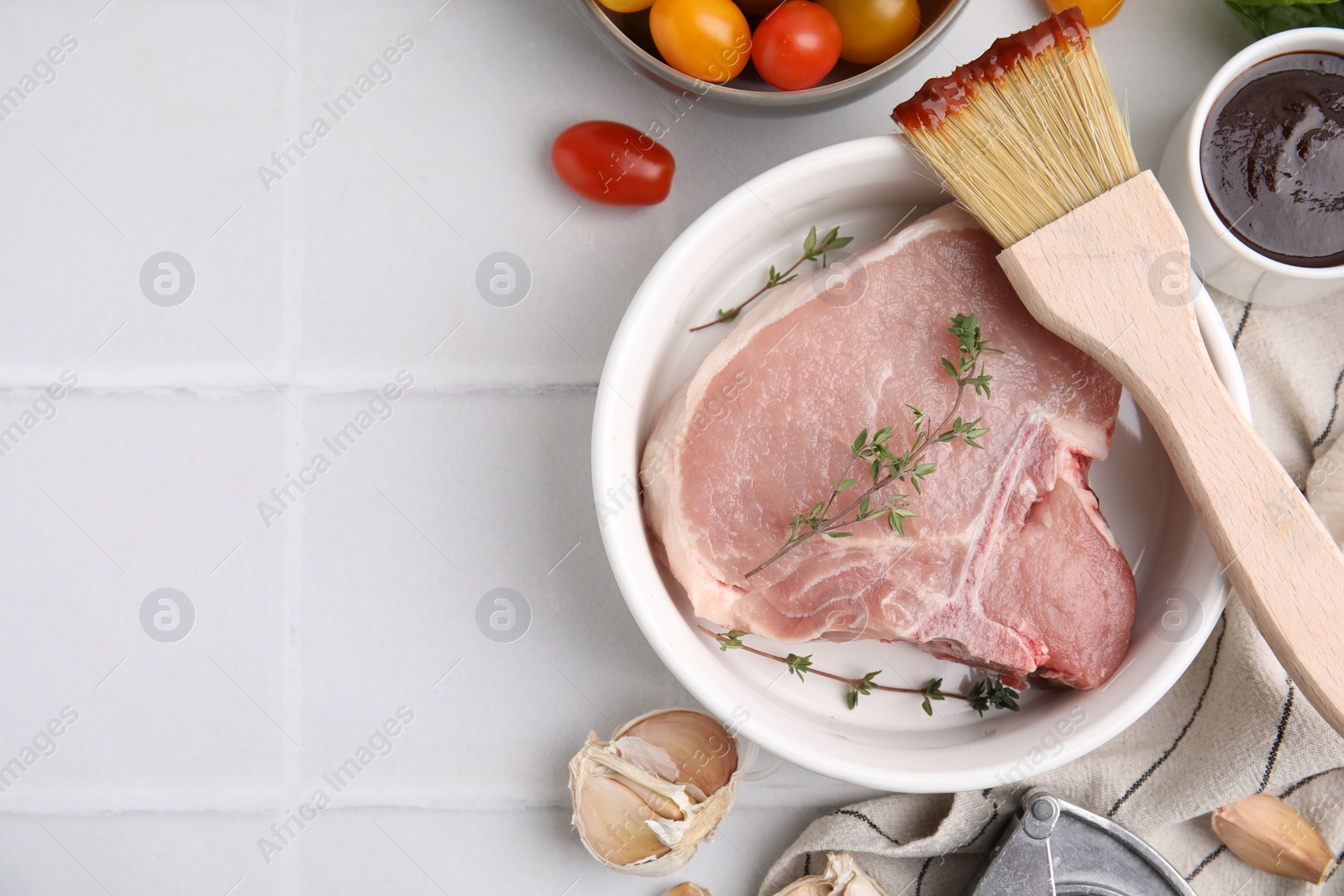 Photo of Flat lay composition with raw meat, thyme and marinade on white tiled table. Space for text