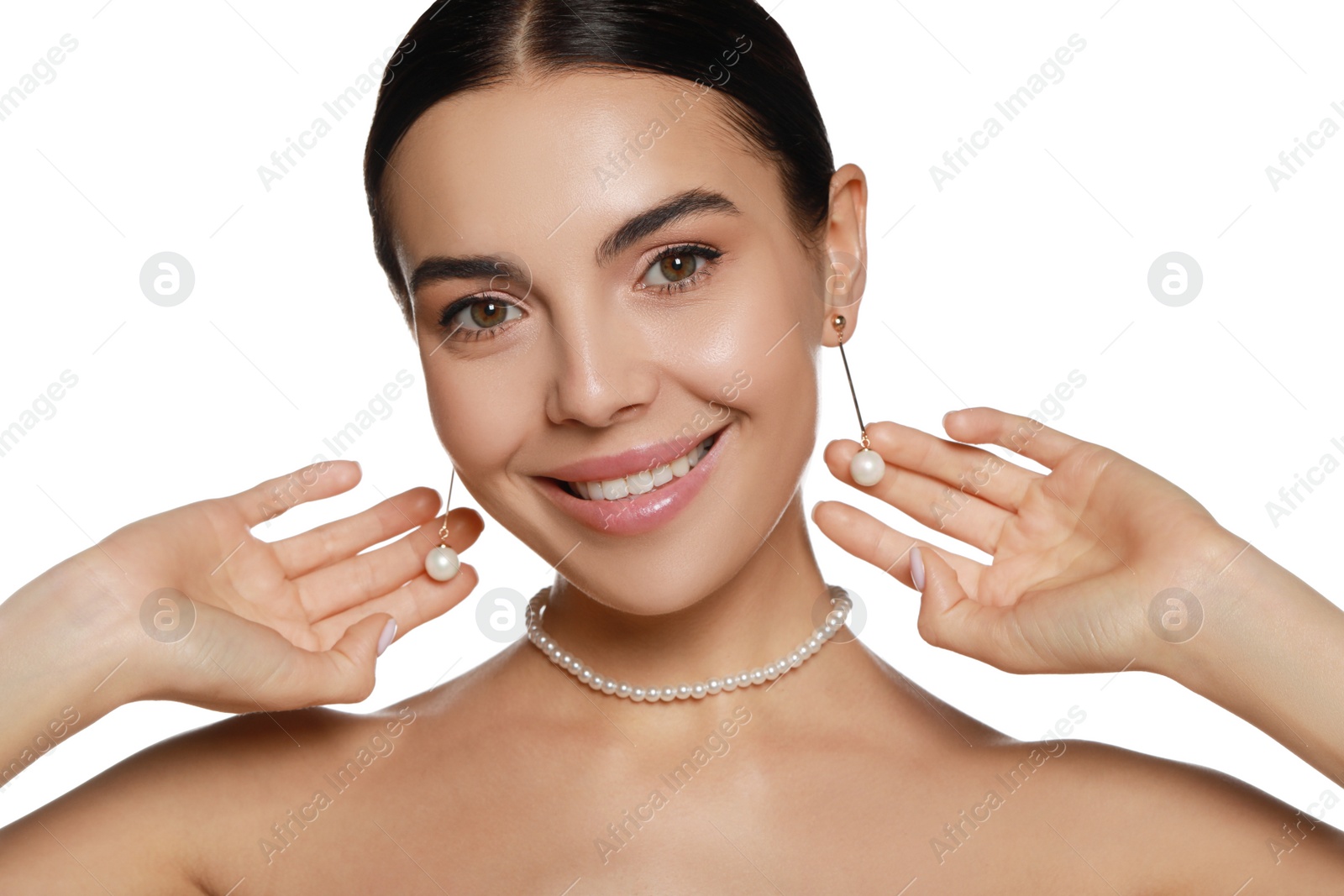 Photo of Young woman wearing elegant pearl jewelry on white background