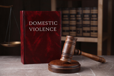 Photo of Domestic violence law and gavel on grey marble table