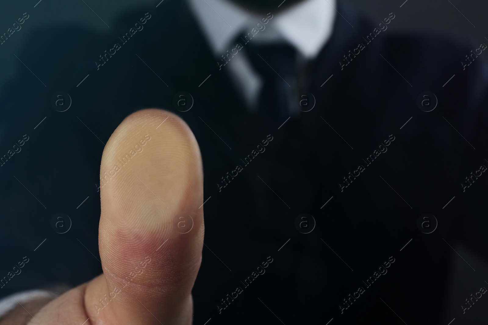 Photo of Businessman pressing control glass of biometric fingerprint scanner, closeup. Space for text