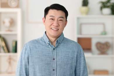 Photo of Portrait of smiling friendly businessman in office