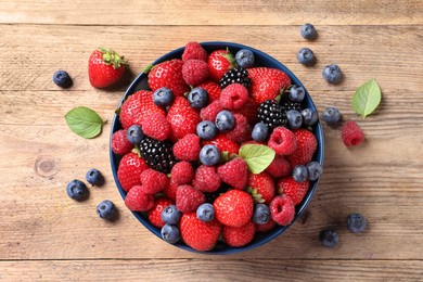 Photo of Different fresh ripe berries on wooden table, flat lay