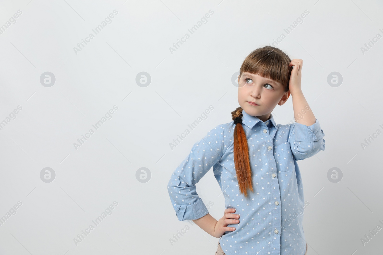 Photo of Pensive little girl on white background, space for text. Thinking about answer to question