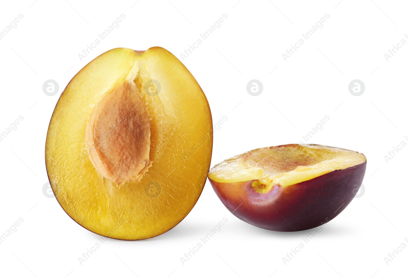 Photo of Halves of fresh ripe plum on white background