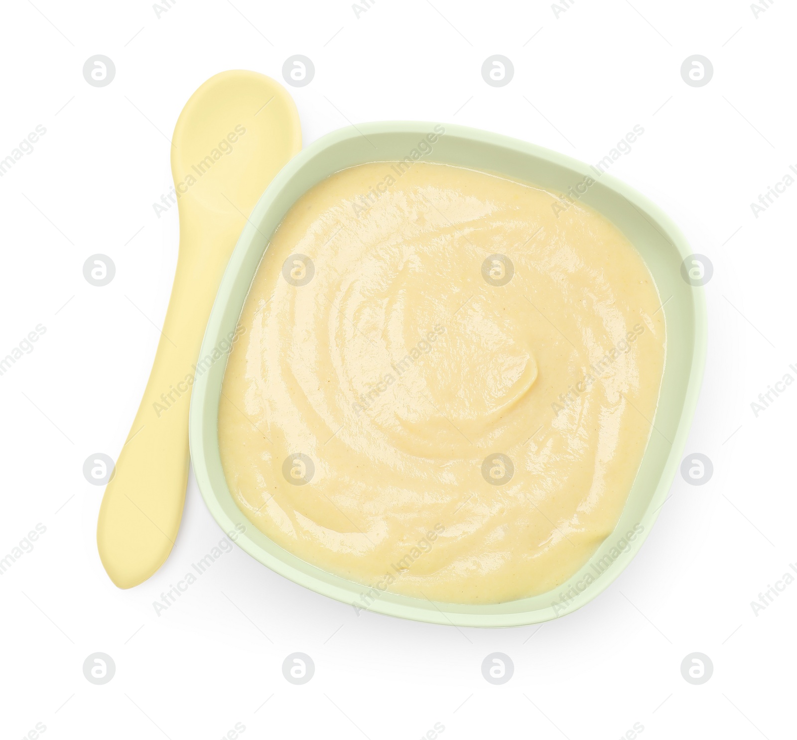 Photo of Tasty baby food in bowl and spoon isolated on white, top view