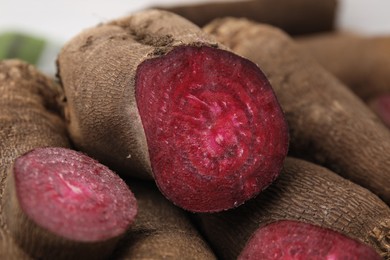 Photo of Ripe whole and cut red beets, closeup
