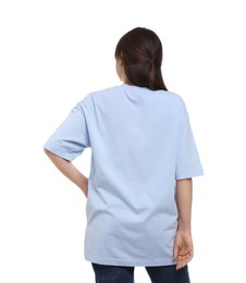 Woman in stylish light blue t-shirt on white background, back view