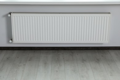 Modern radiator on white wall in office. Interior design