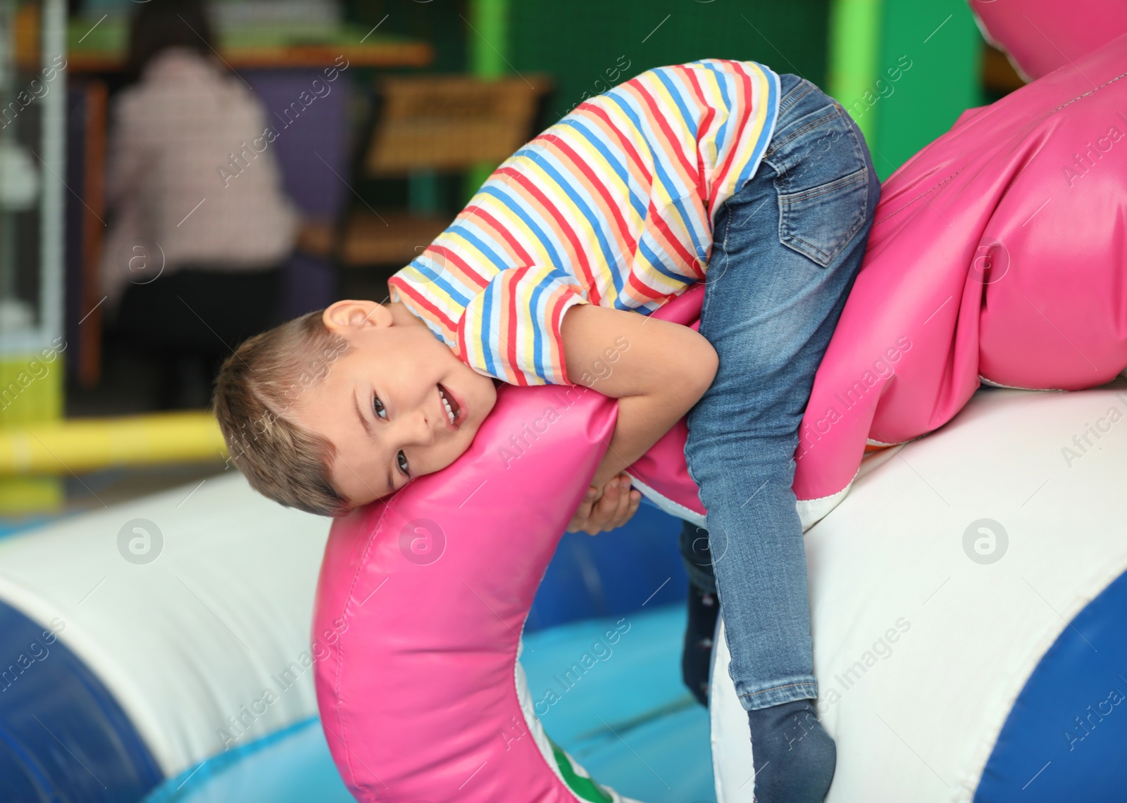 Photo of Cute little child playing at indoor amusement park