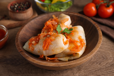 Photo of Delicious cabbage rolls on wooden table, closeup