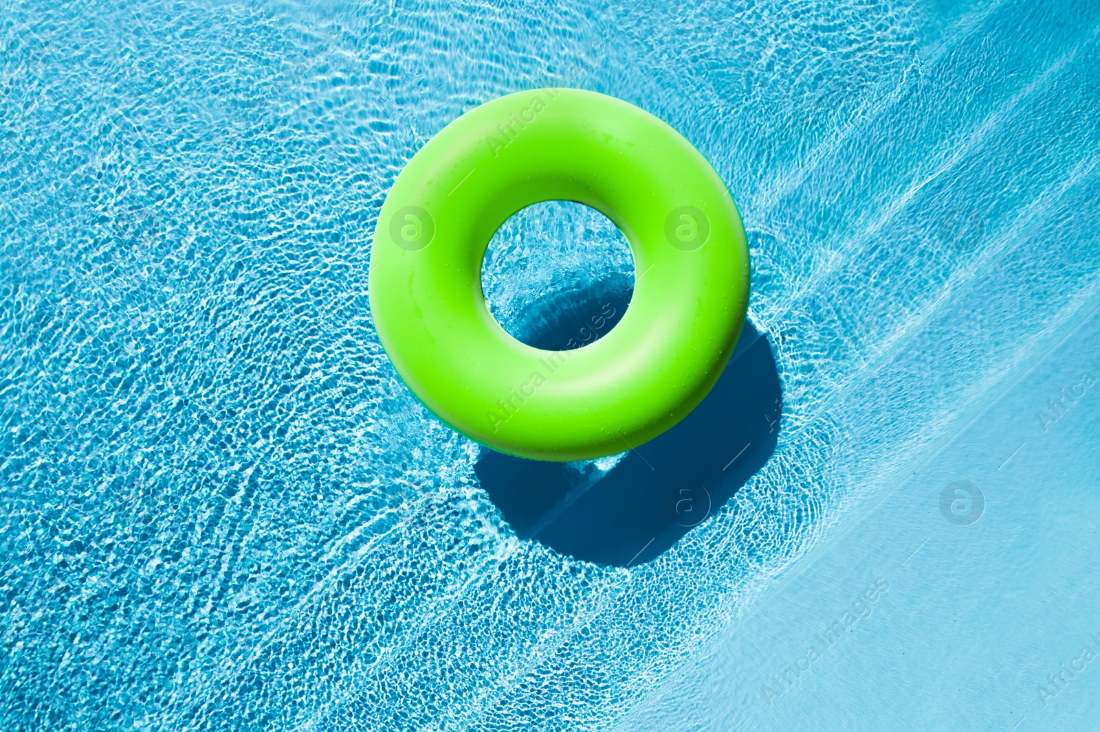 Image of Inflatable ring floating in swimming pool, top view. Summer vacation