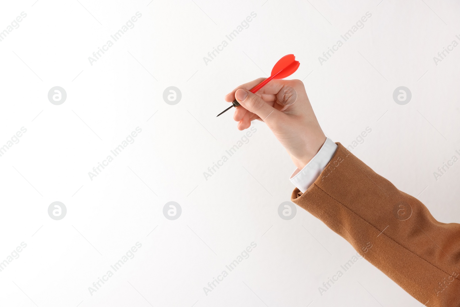 Photo of Businesswoman holding red dart on white background, closeup. Space for text