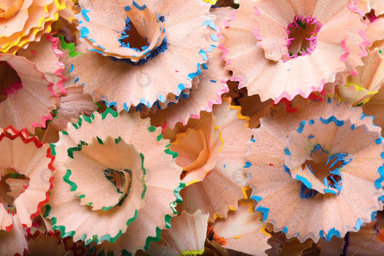 Photo of Pile of colorful pencil shavings as background, top view