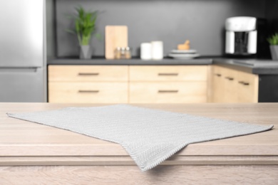 Photo of Napkin on wooden table in kitchen. Mockup for design
