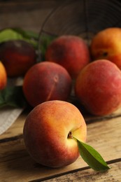 Fresh ripe juicy peaches on wooden table, closeup