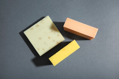 Hand made soap bars on grey background, top view