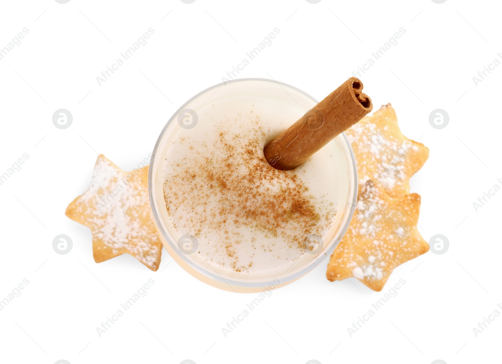 Photo of Delicious eggnog with cinnamon in glass and cookies isolated on white, top view