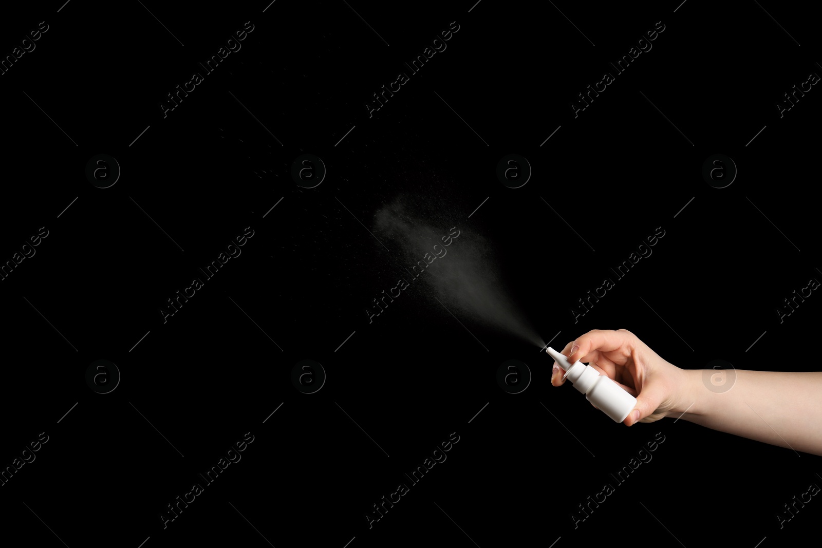 Photo of Nasal congestion. Woman spraying remedy from bottle on black background, closeup with space for text