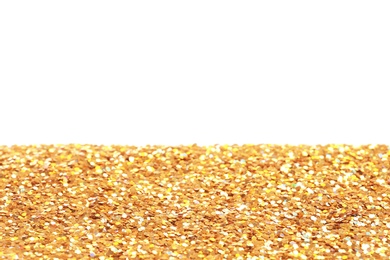 Photo of Many shiny golden paillettes against white background