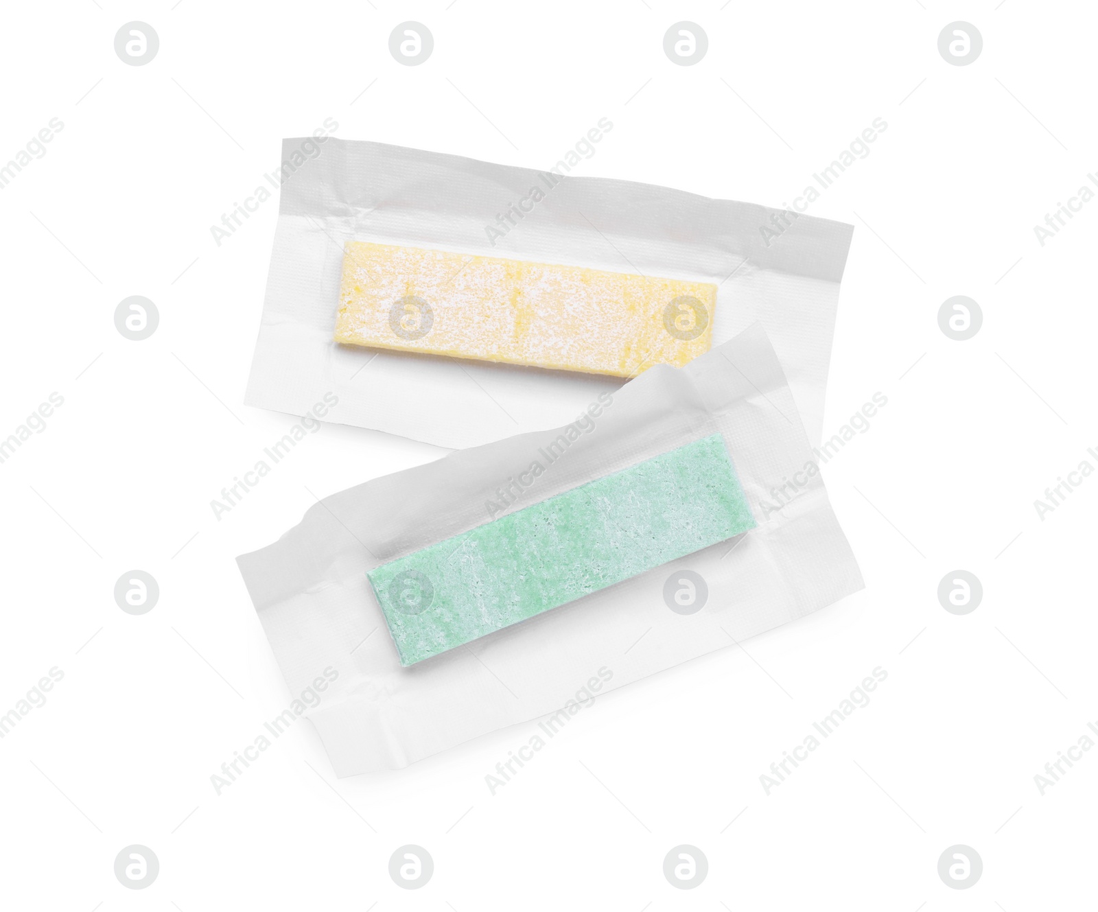 Photo of Unwrapped sticks of chewing gum on white background, top view