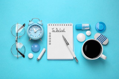 Photo of Flat lay composition with unfilled To Do list, glasses and cup of coffee on light blue background