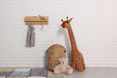 Photo of Beautiful children's room with white brick wall and toys. Interior design