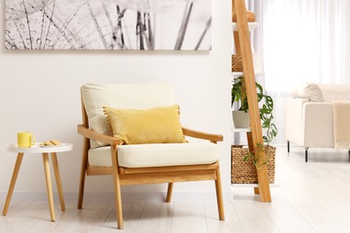 Photo of Spring atmosphere. Cosy armchair and coffee table in stylish room