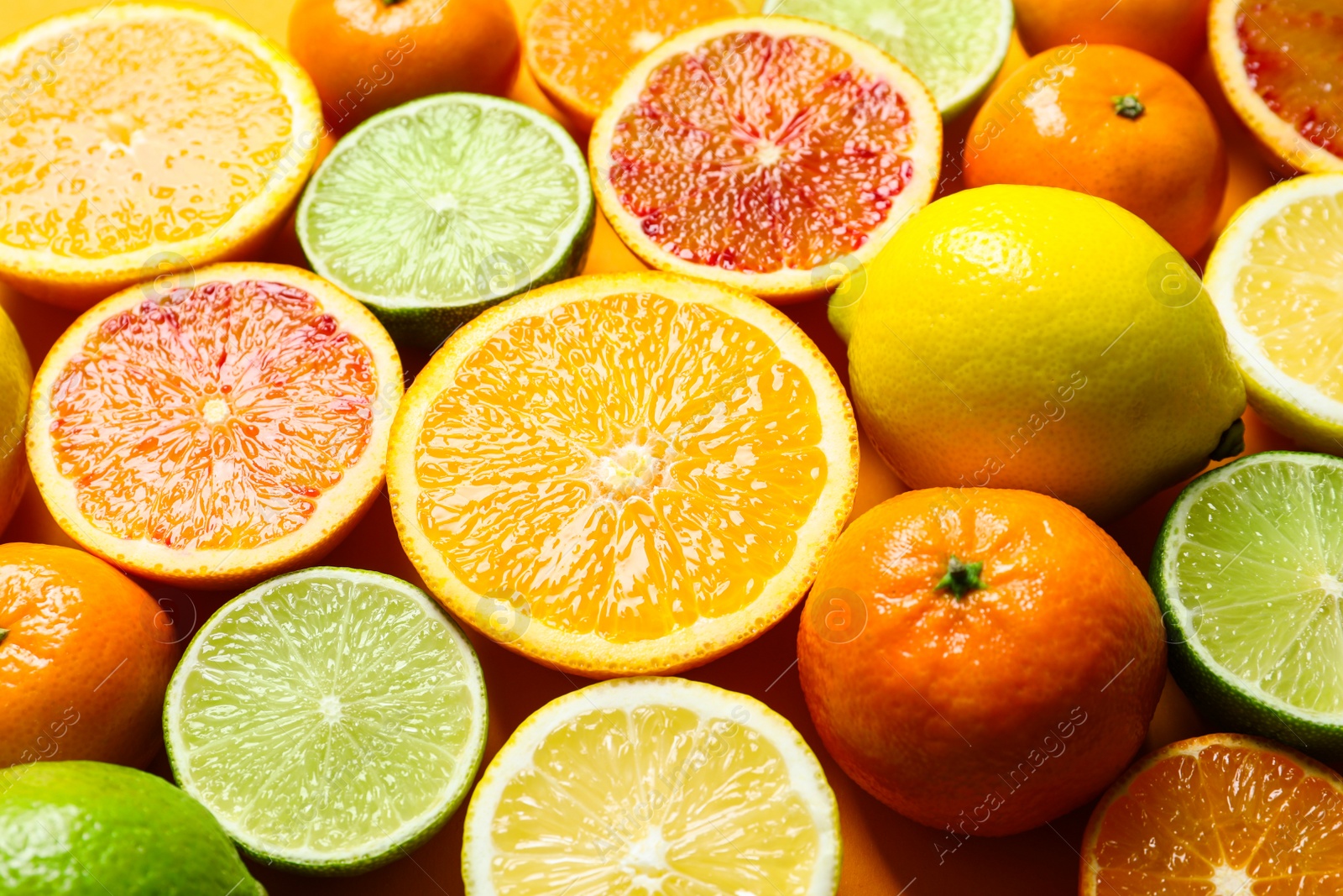 Photo of Different citrus fruits on color background, closeup