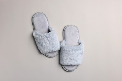 Photo of Pair of soft slippers on light grey background, top view