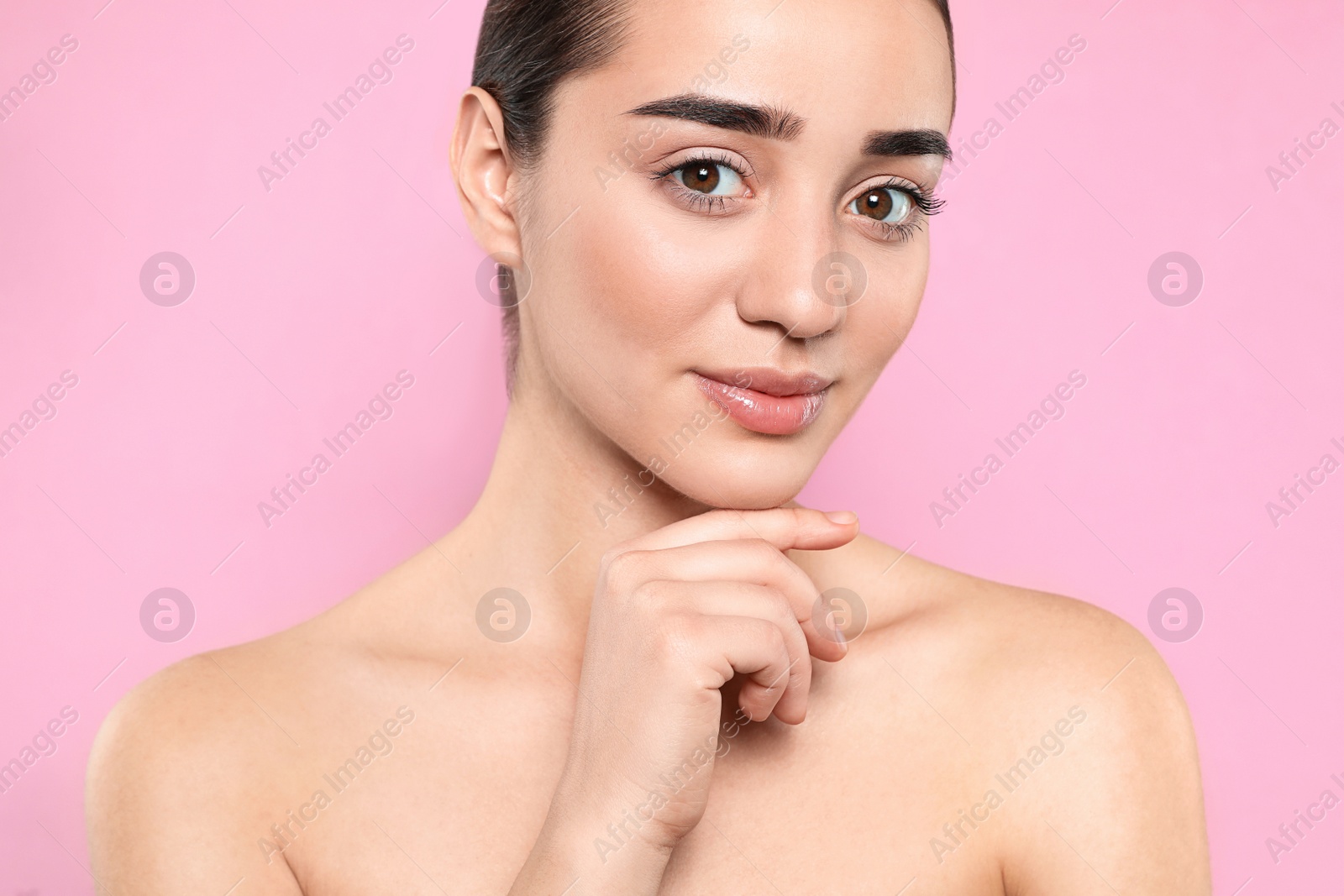 Photo of Portrait of young woman with beautiful face against color background