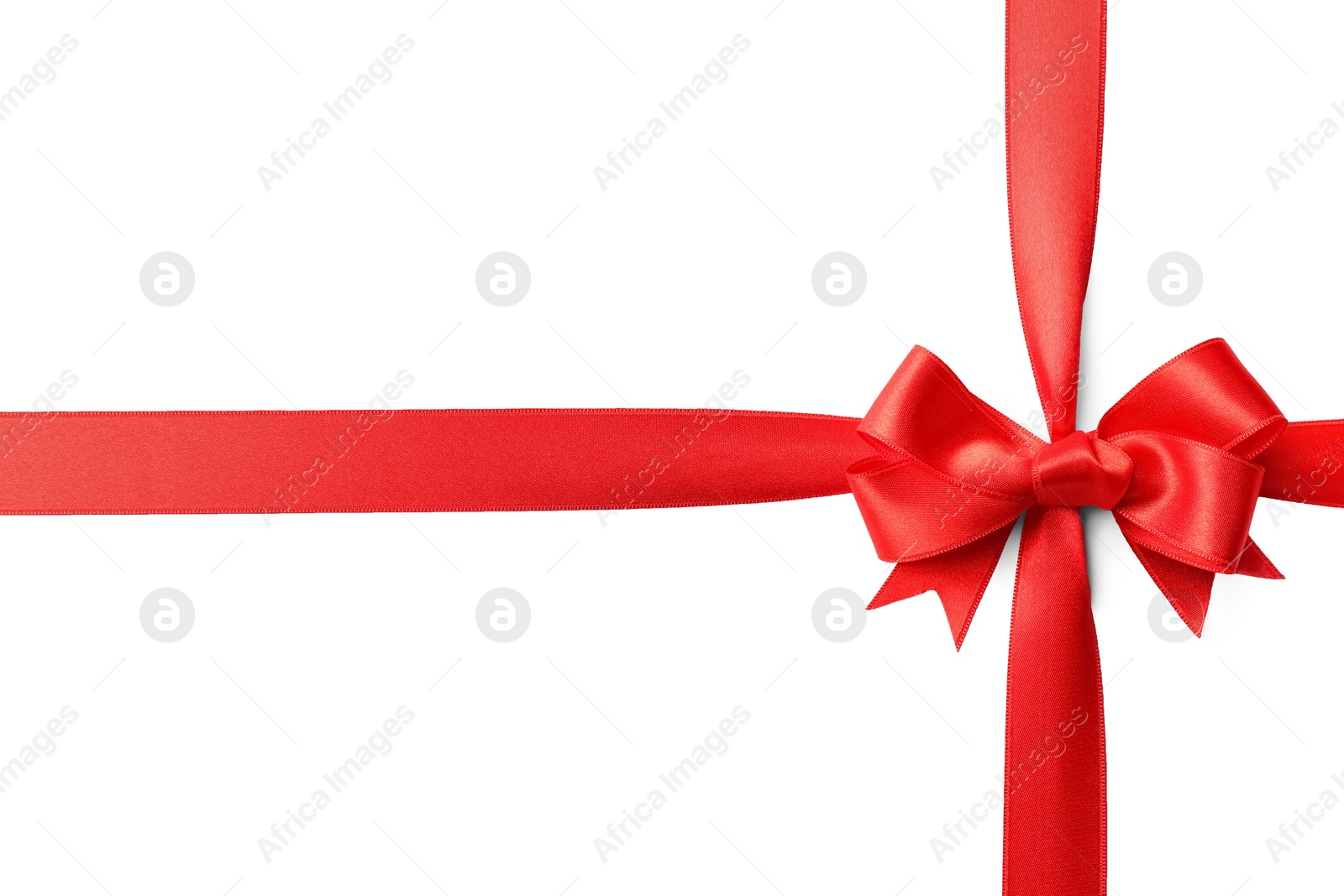 Photo of Red ribbon with bow on white background. Festive decoration