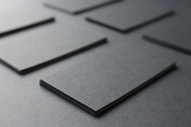 Photo of Blank business cards on black background, closeup. Mockup for design