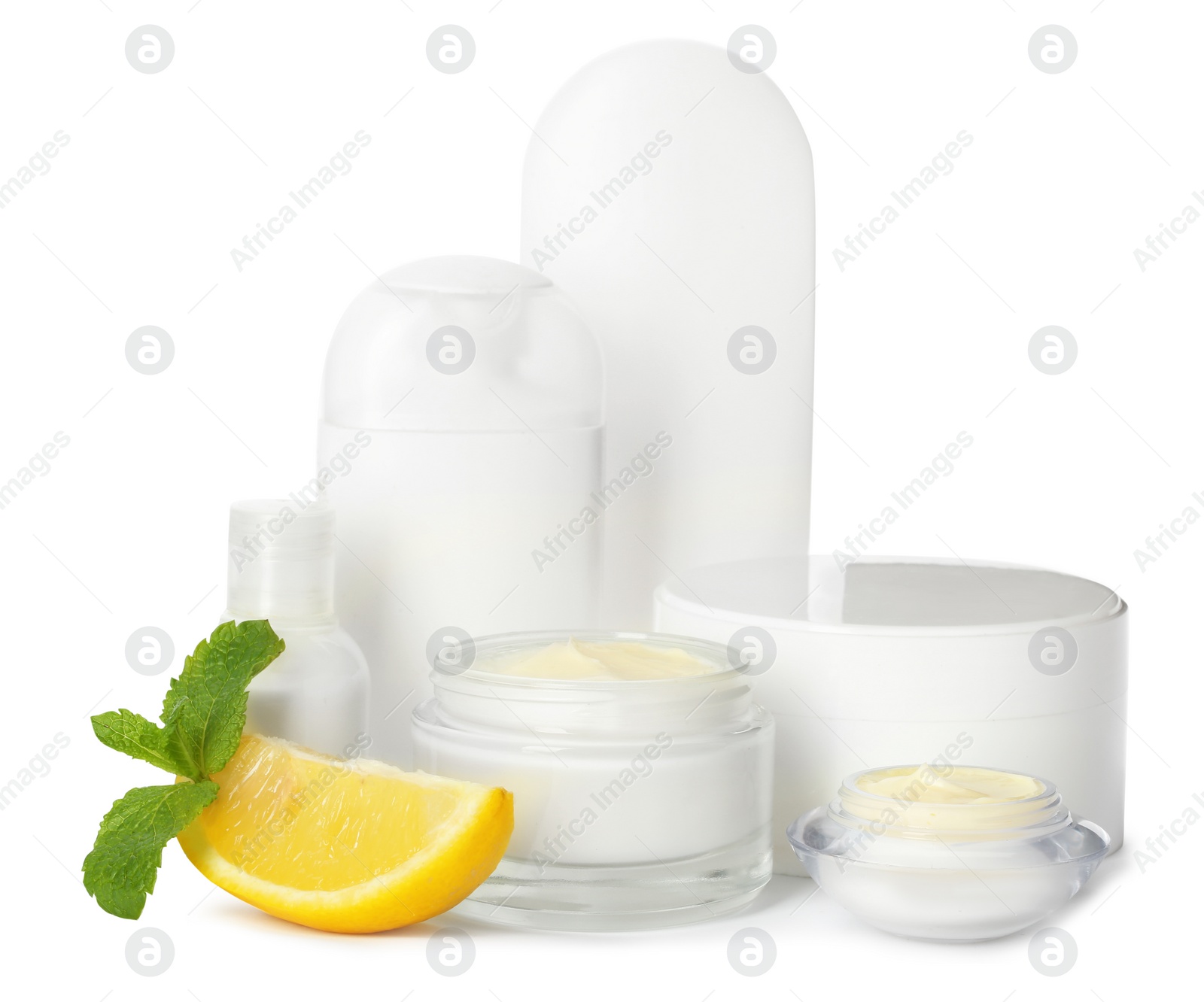 Photo of Jars with cream and bottles on white background. Hand care cosmetics