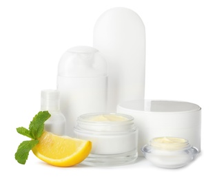 Photo of Jars with cream and bottles on white background. Hand care cosmetics